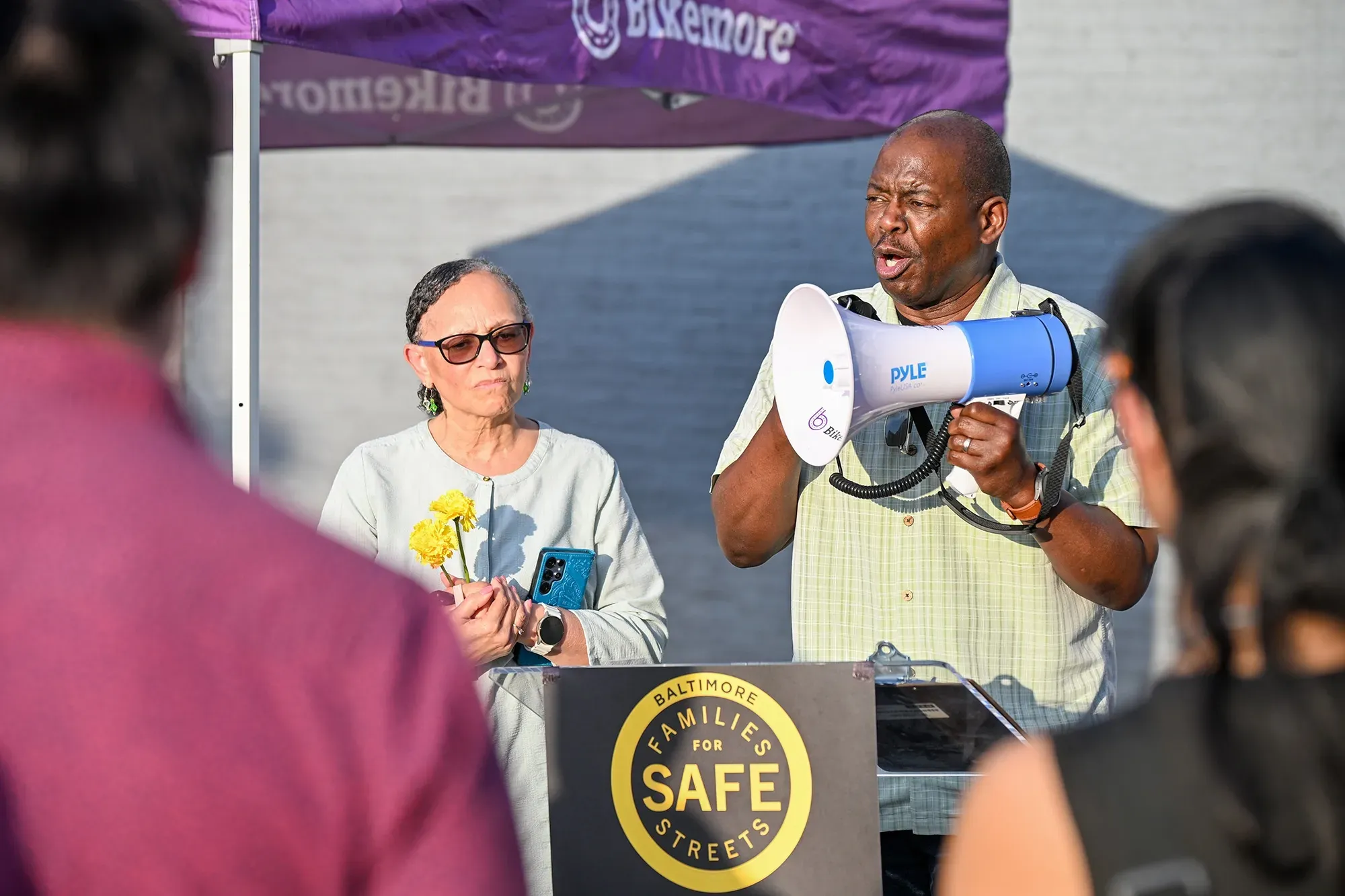 an image of a pastor speaking at a vigil on the Orleans Street corridor